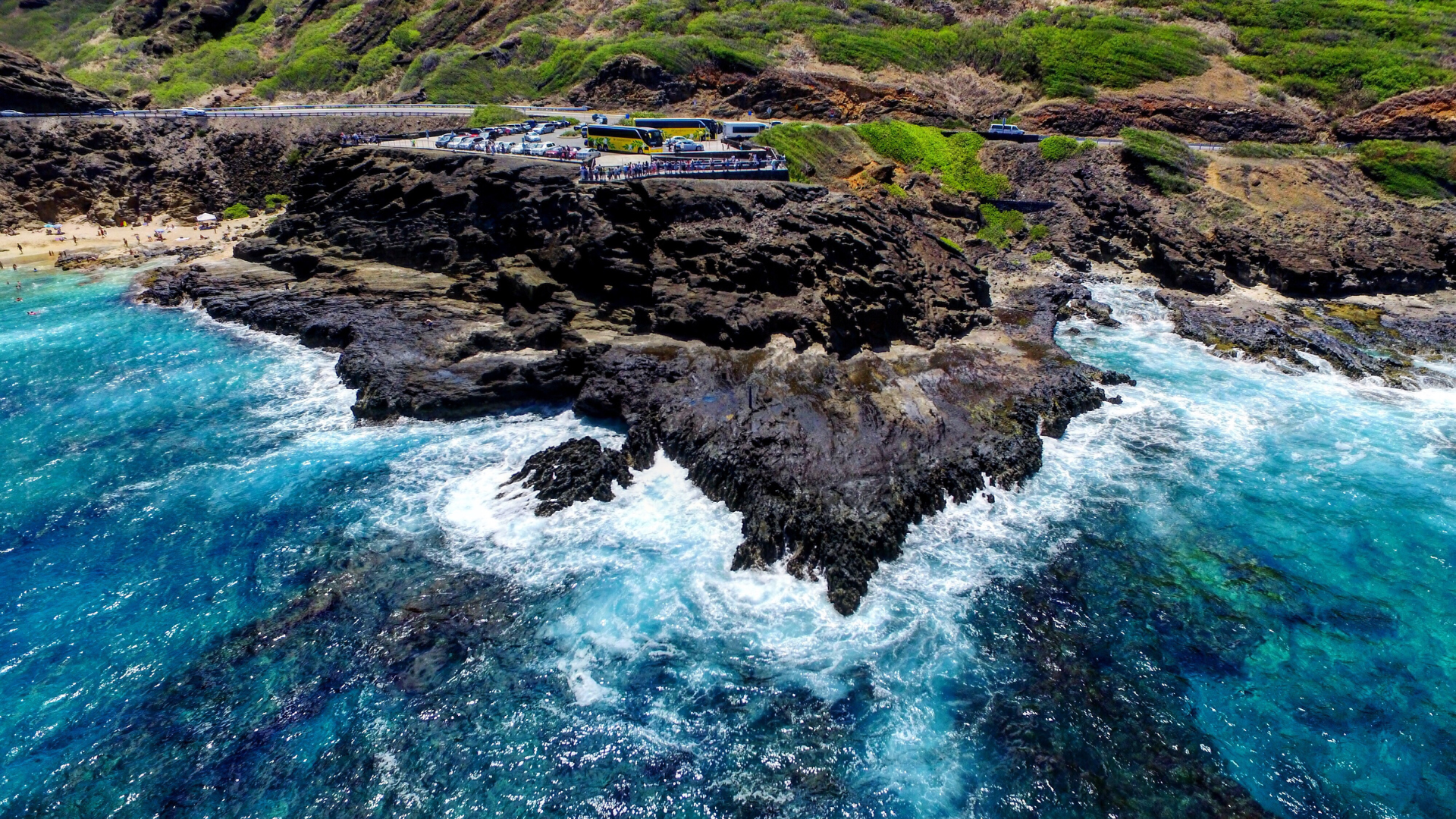 An aerial view of a rocky shoreline next to a body of water.