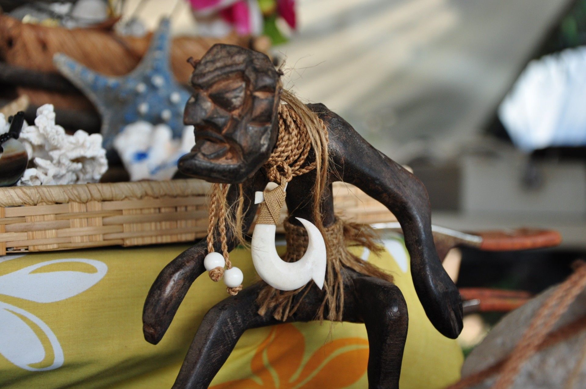 A statue of a monkey with a fish hook around his neck