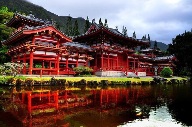 A large red building with a pond in front of it