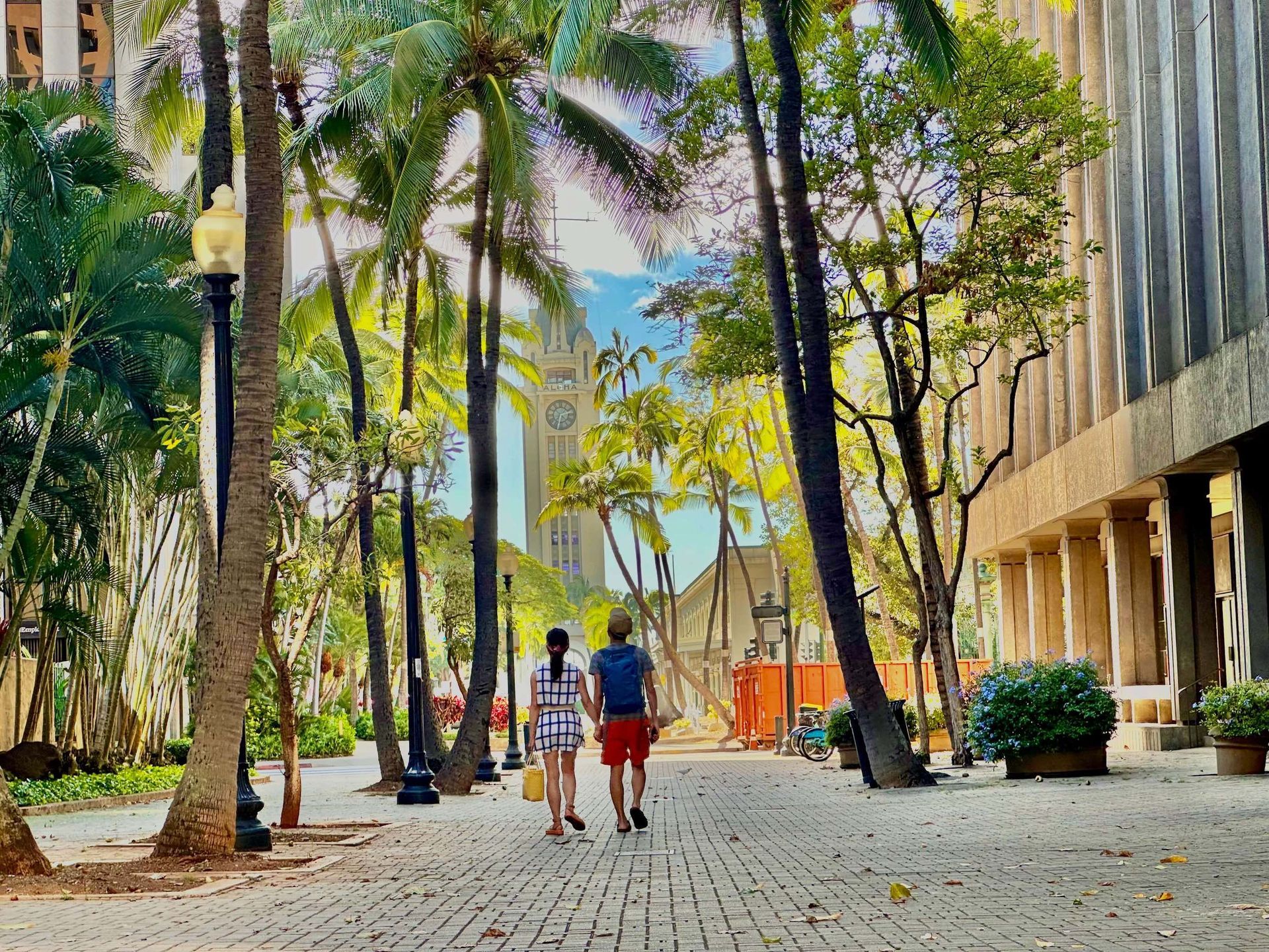 A couple holding hands with the words love on the lava rocks below them