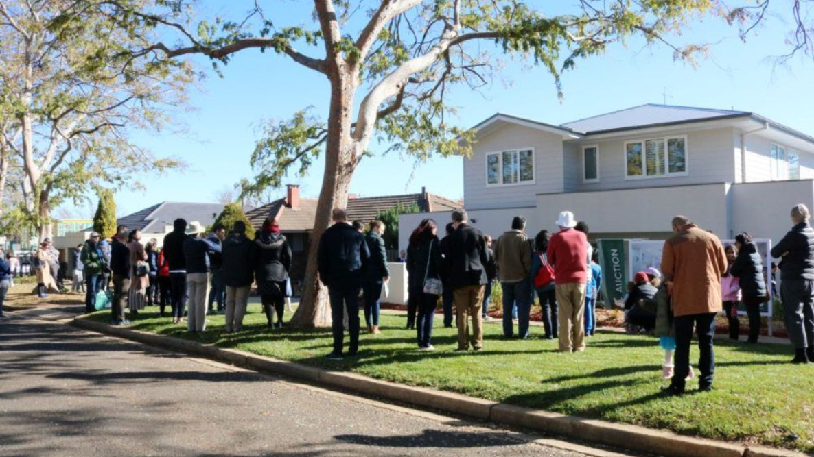 Handshake as house key is passed, suggesting a property transfer.