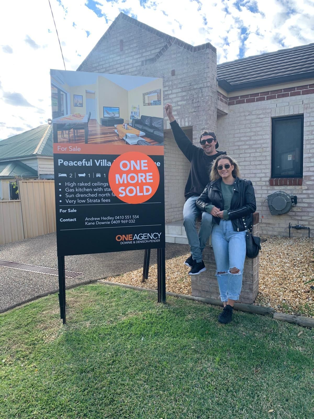 Couple celebrates in front of a 