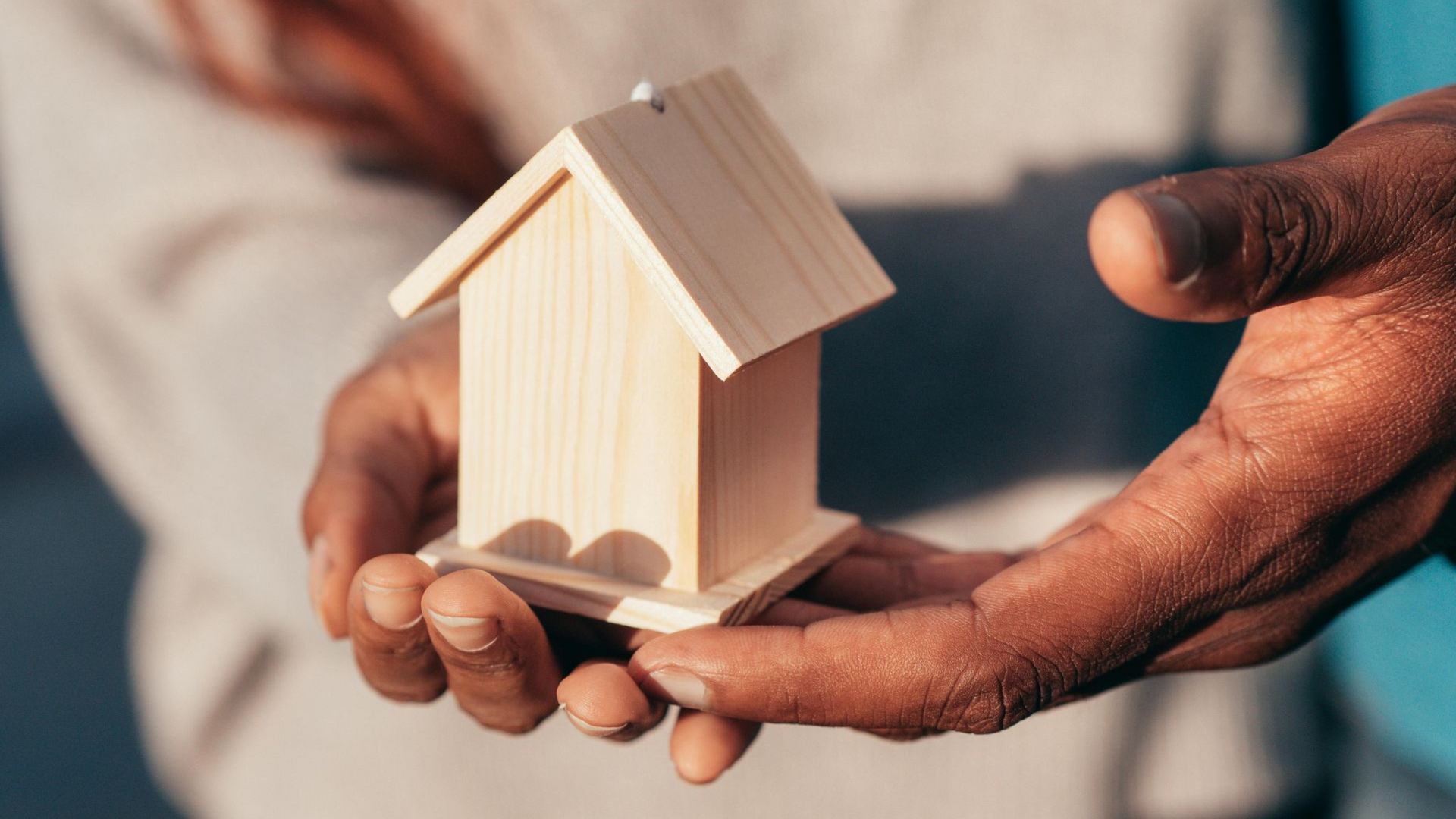 Modern living room with sectional sofa, coffee table, and large windows.