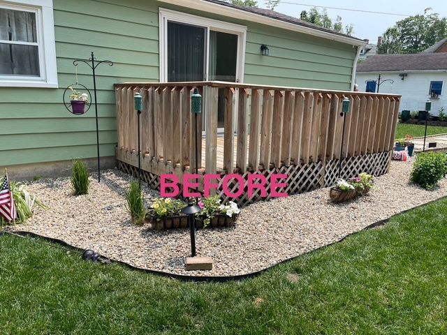A before picture of a house with a deck and gravel.