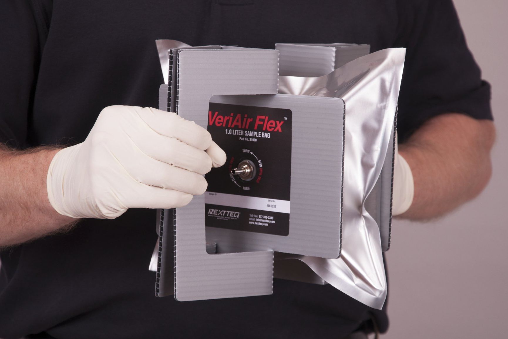 A man is taking an air sample using a VeriAir Flex® Foil Sampling Bag.