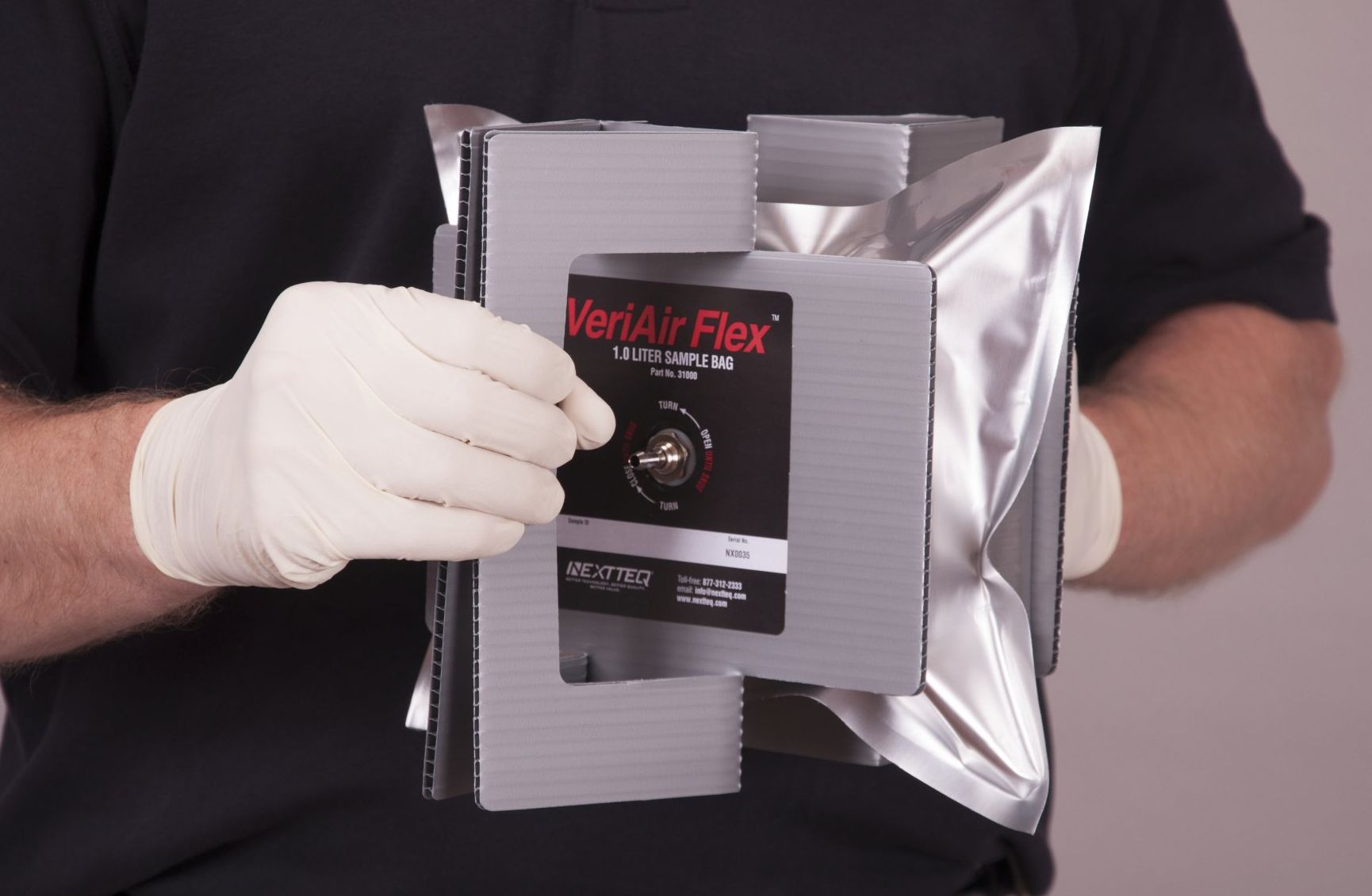 A man is taking an air sample using a Nextteq® VeriAir Flex® foil sample bag.