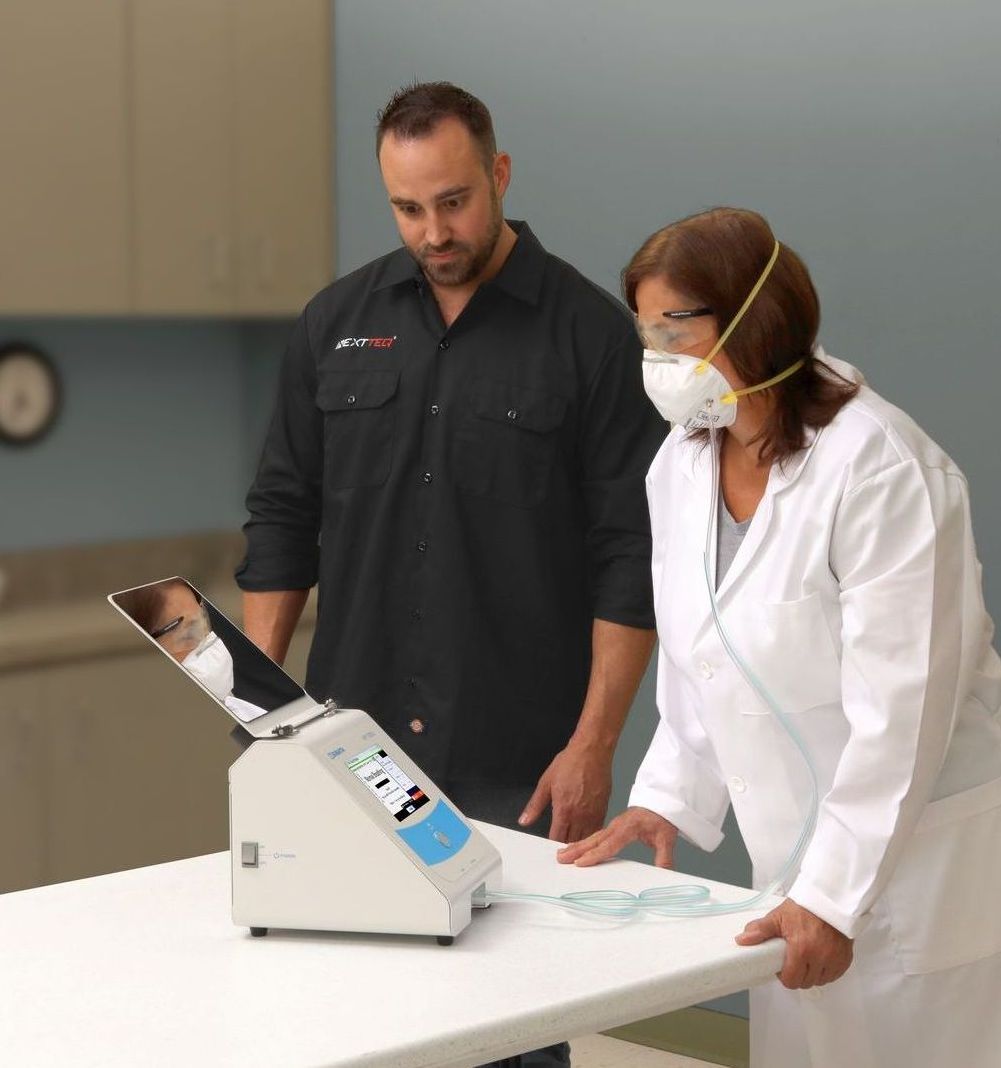 A hand demonstrating how to use the Nextteq® VeriFit® Irritant Smoke Generator. Step 3. Compress the bellows and smoke is generated.