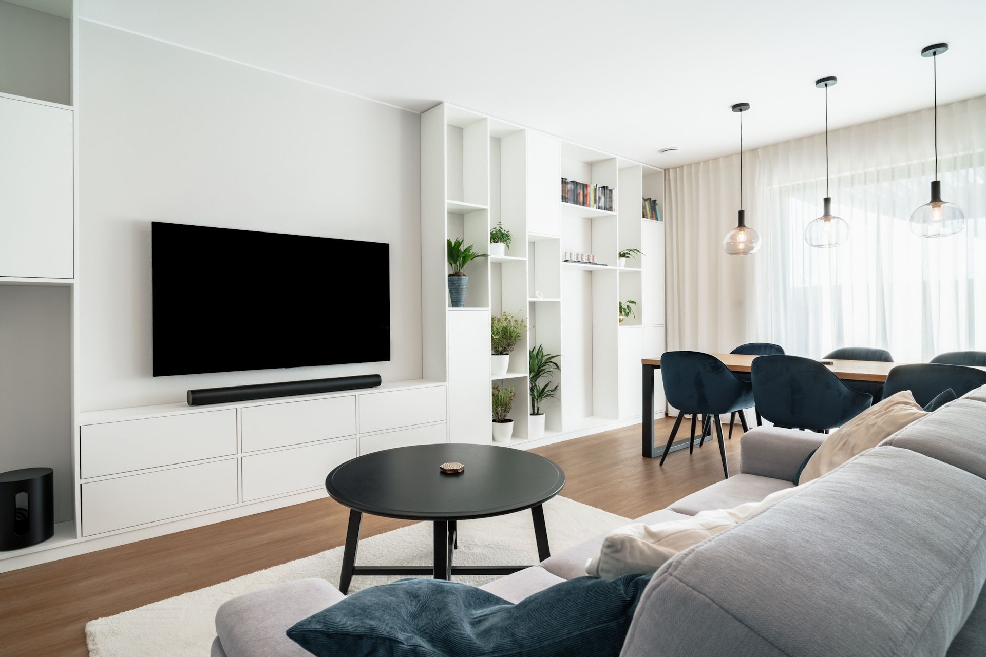 A living room with a couch , table , and television.