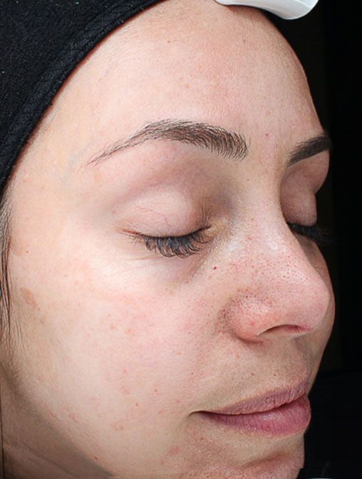 A close up of a woman 's face with her eyes closed.