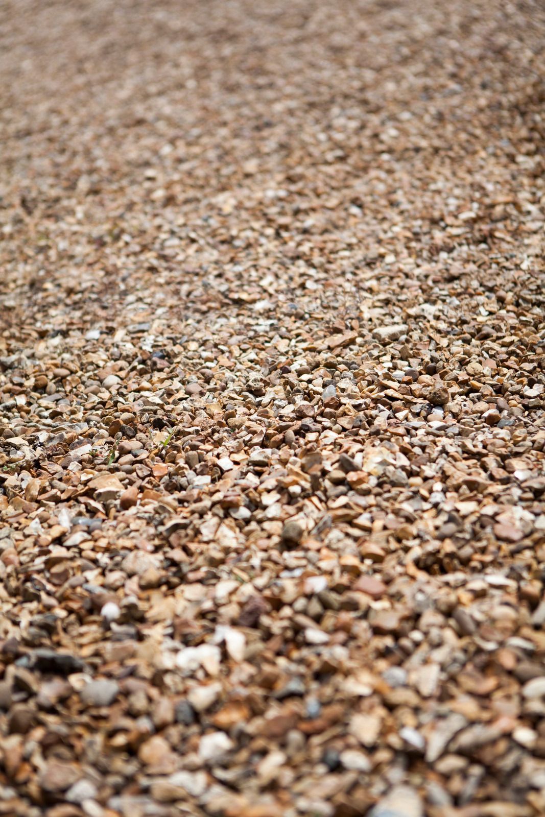 A close up of a pile of gravel on a beach.