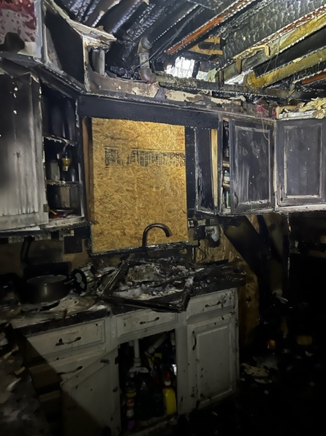 A housefire destroyed this home, the kitchen is covered in ash and black soot