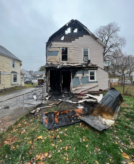 A severely burned home near Akron Ohio. The siding is melted off, the back door was blown off into the yard and pieces of the home are scattered