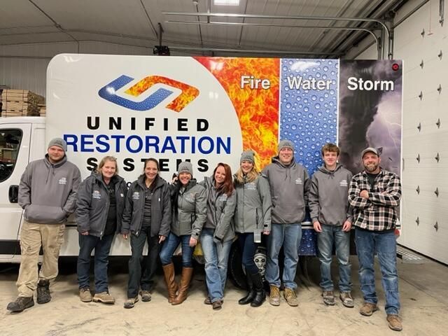 Unified Restoration Systems Team photo with company van