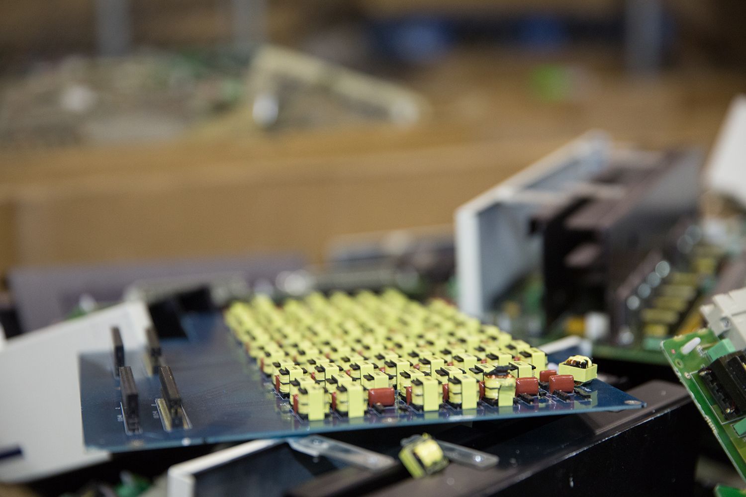 A bunch of electronic components are sitting on top of each other on a table.