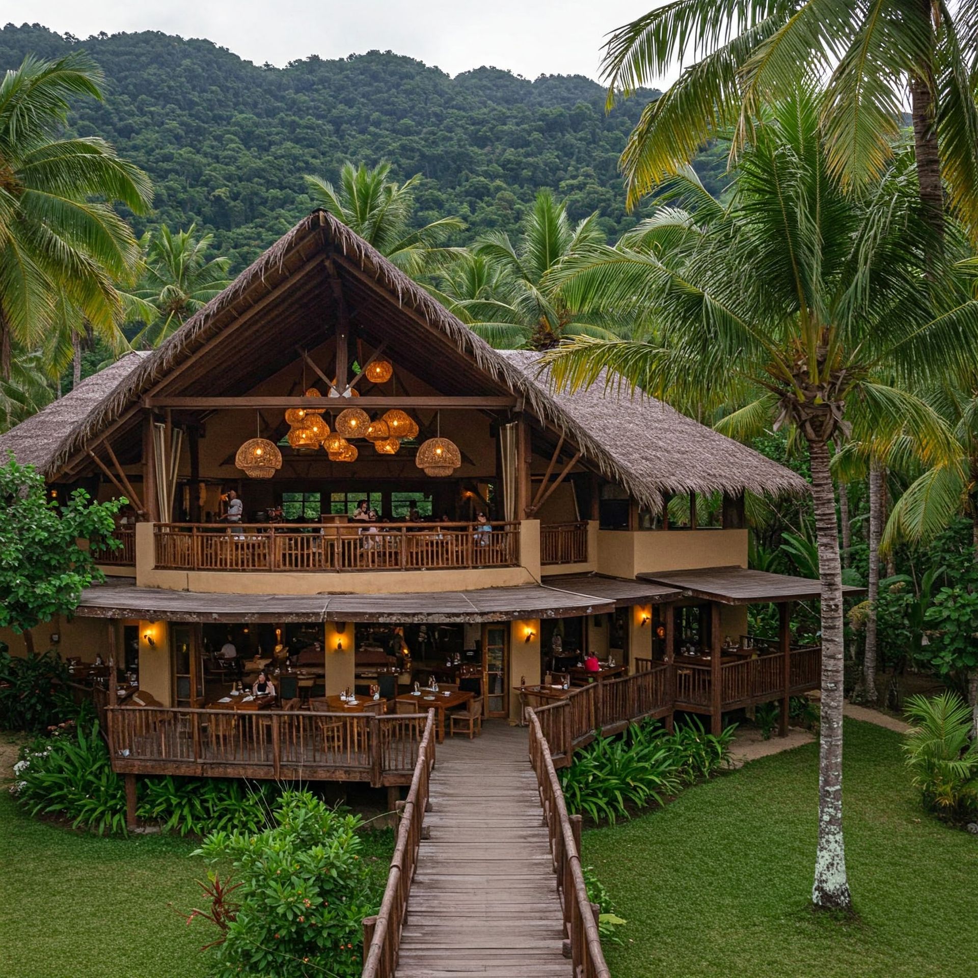 A house with a thatched roof is surrounded by palm trees. Best place where to eat in Puerto Princesa