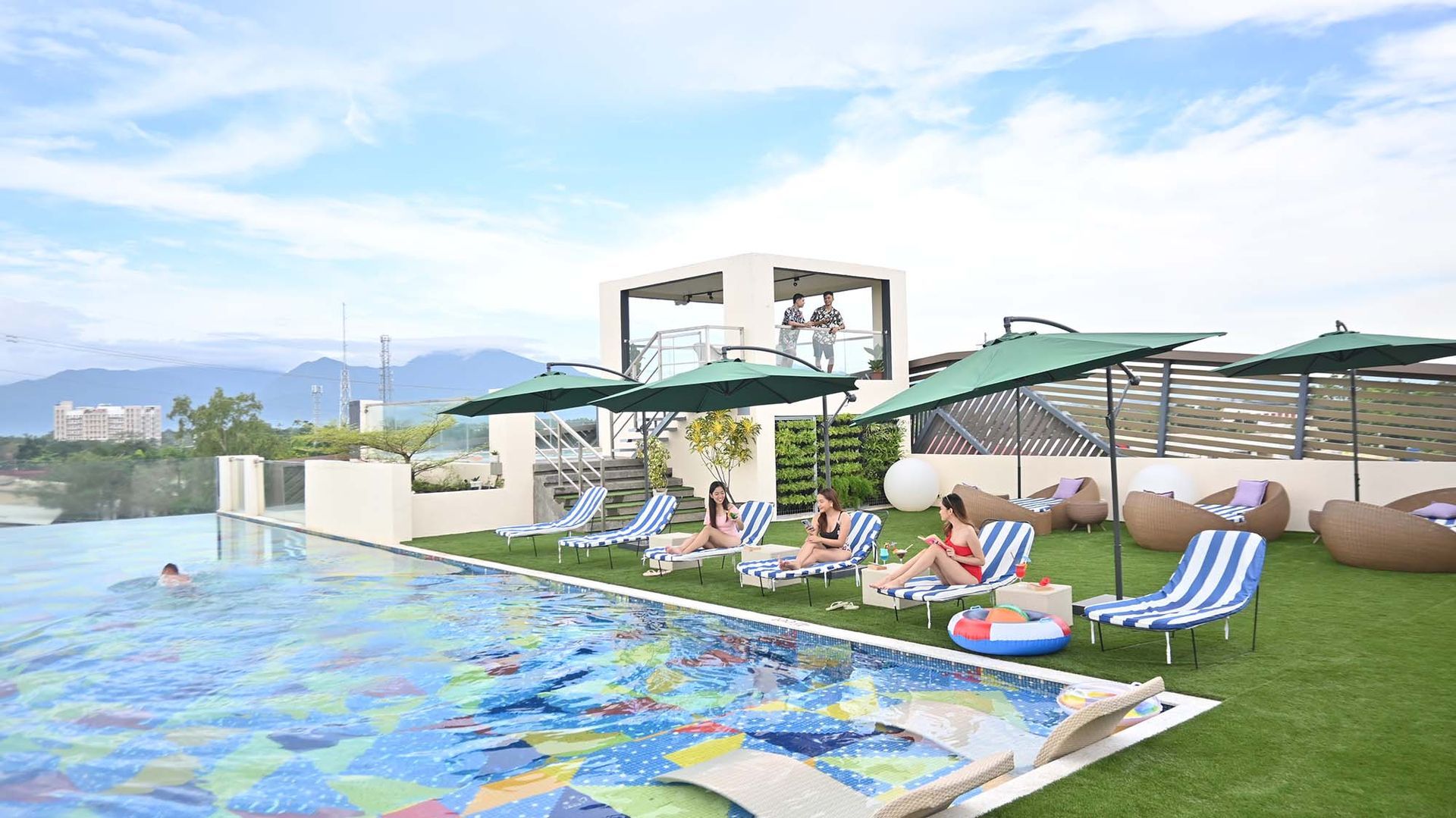 A rooftop pool in palawan with umbrellas and chairs 
