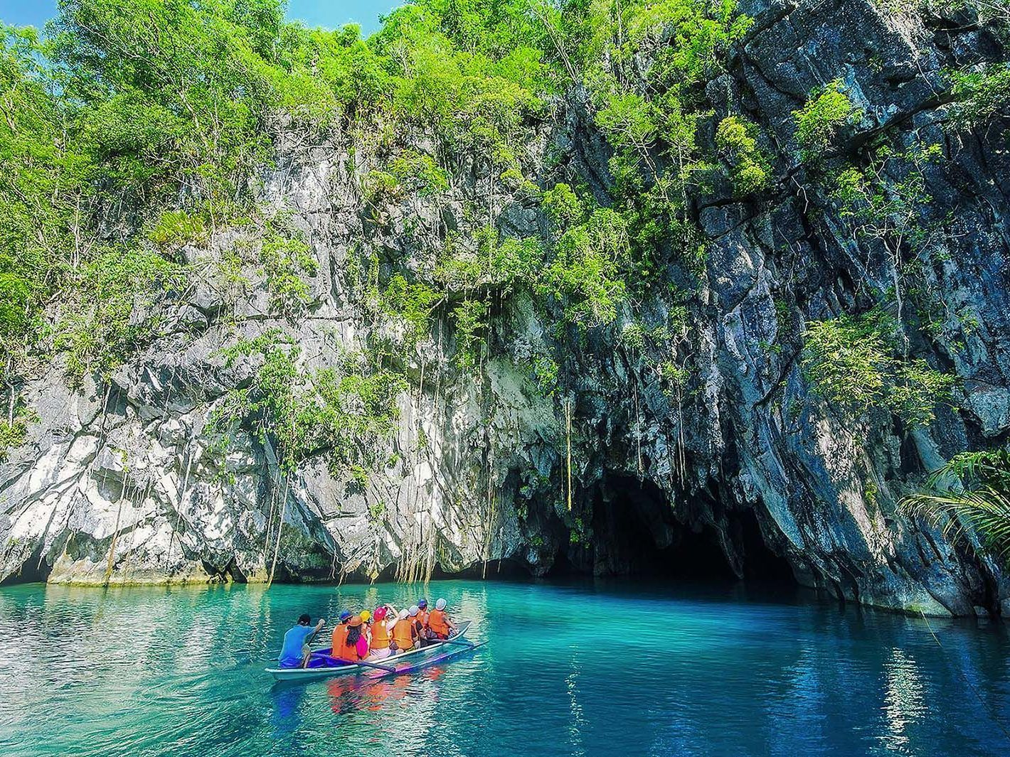 Underground River entrance near best Puerto Princesa hotel's which is a must-visit attraction, with tourists on paddleboat