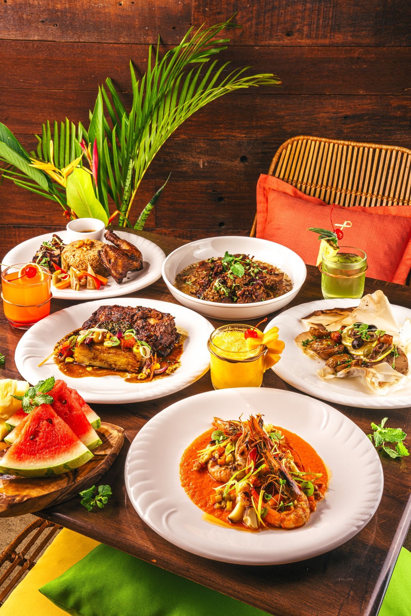 A table topped with plates of food and drinks at La-Ud 