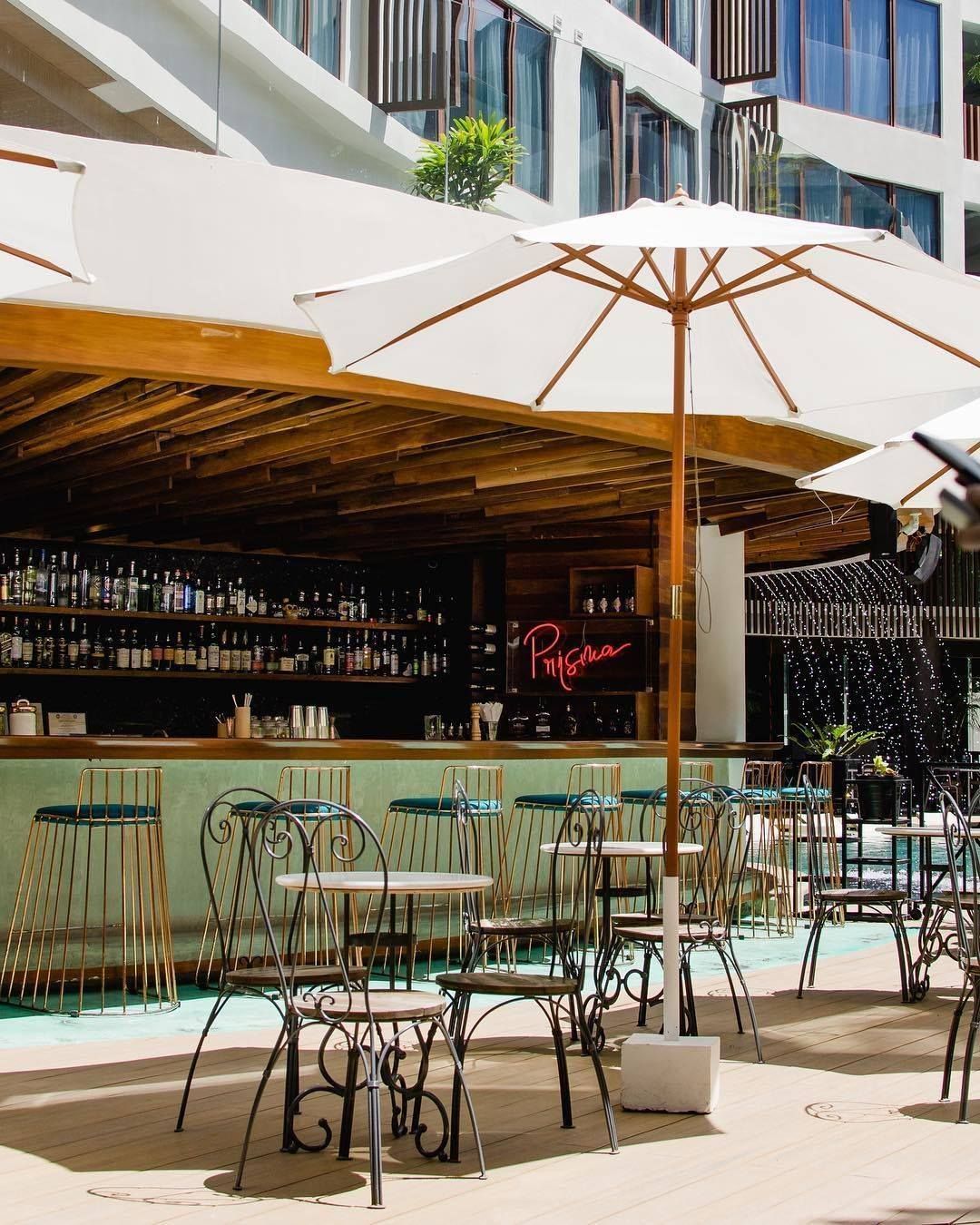 Tables and chairs under umbrellas outside