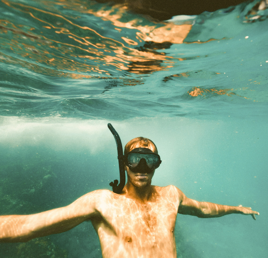Snorkeling adventure in crystal-clear waters at Puerto Princesa's beach destinations accessible from Hue Hotel