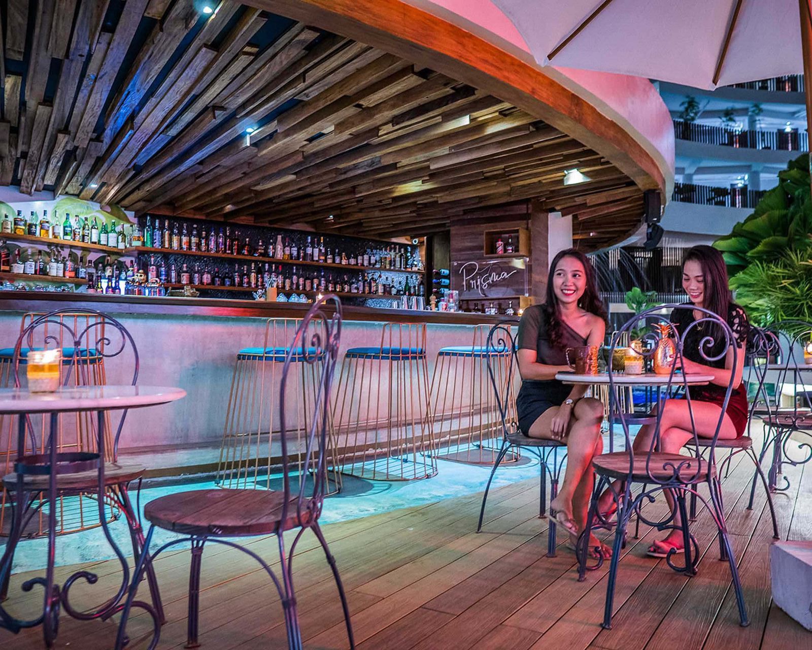 Two women are sitting at tables at Station X