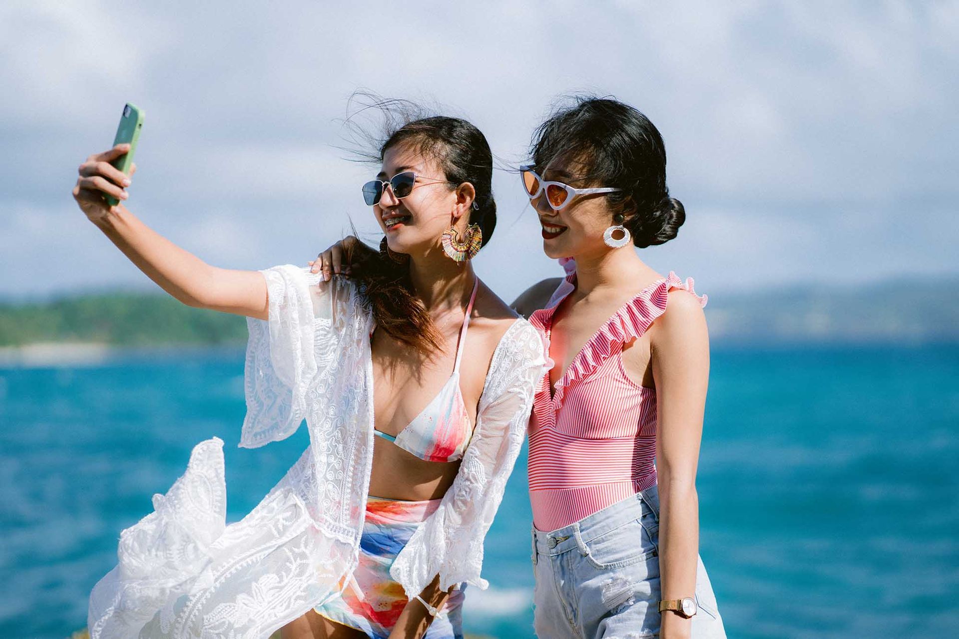 Two women are taking a selfie on the boracay beach