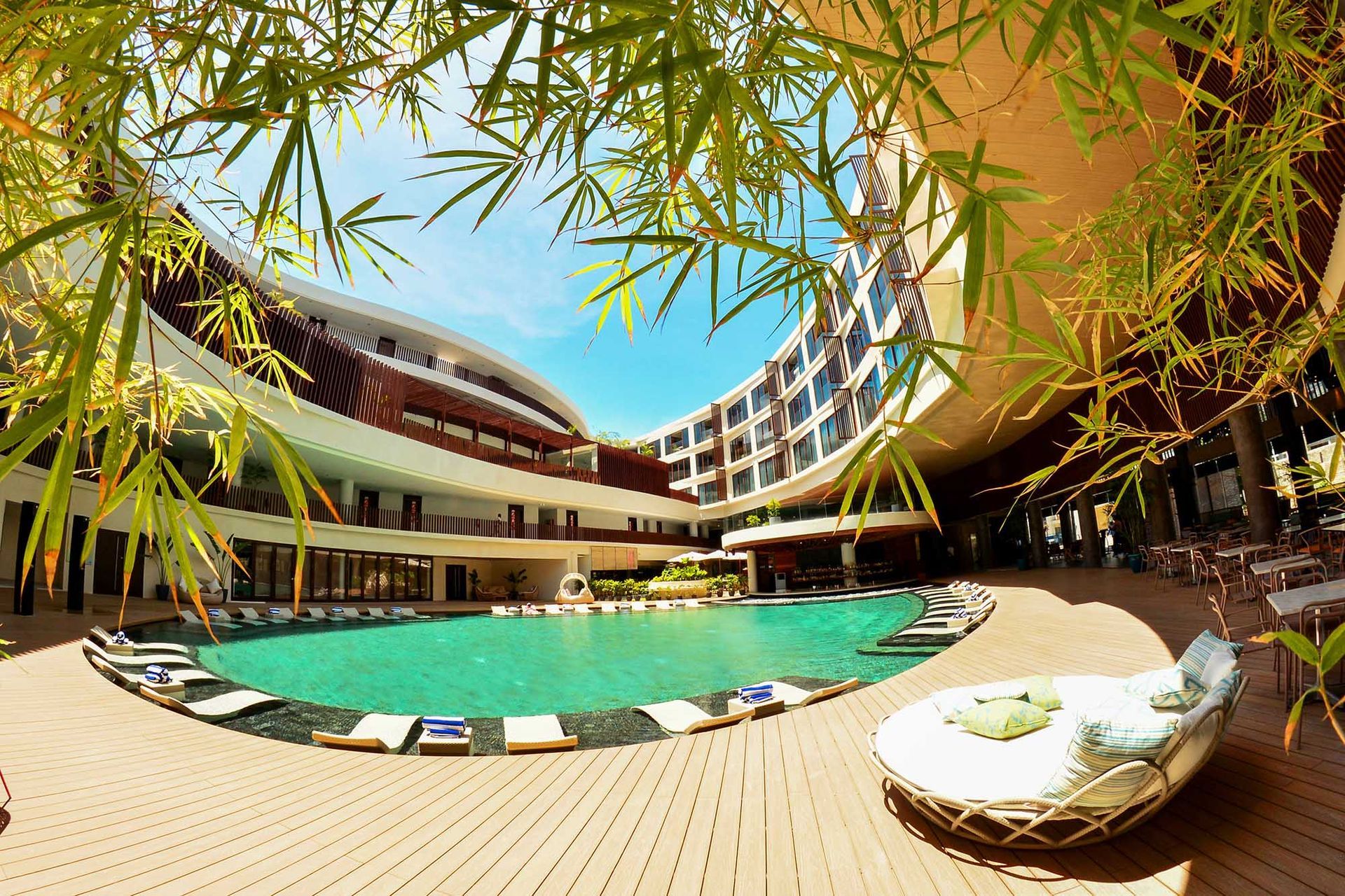 A large swimming pool in front of a hotel