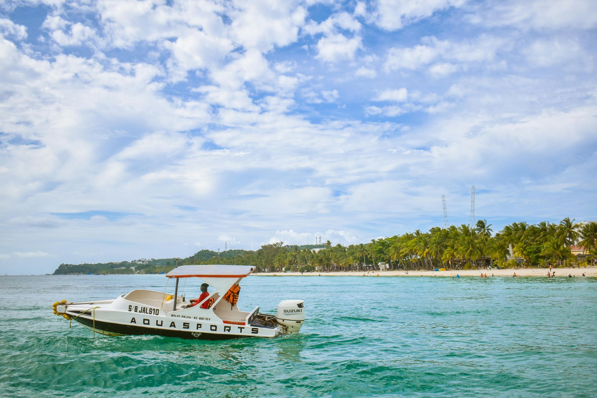 Tourist boat near family-friendly hotels in Boracay with clear turquoise waters