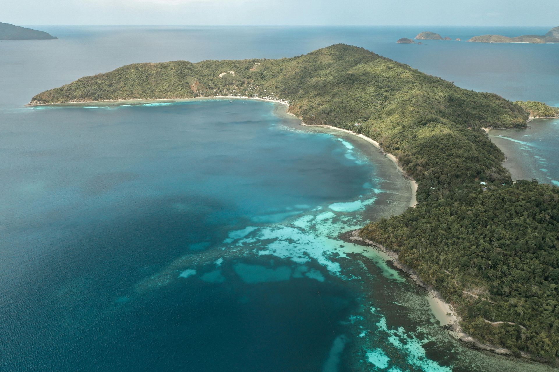 An aerial view of a small island in the middle of the ocean.