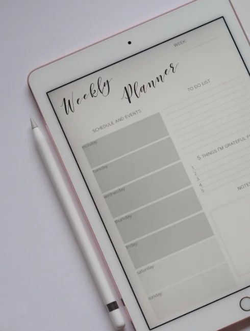 A tablet with a weekly planner on it