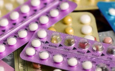 A close up of a pile of contraceptive pills on a table.