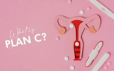 A pink background with a uterus , a pregnancy test , and pills.