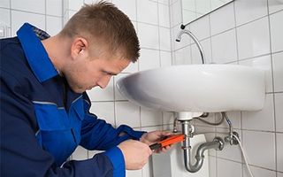 Drain Cleaner — A plumber fixing a sink in Savannah, GA