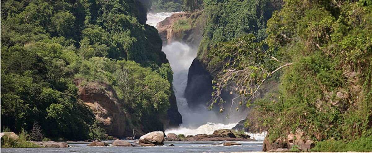 Waterfall cascading between lush green cliffs.