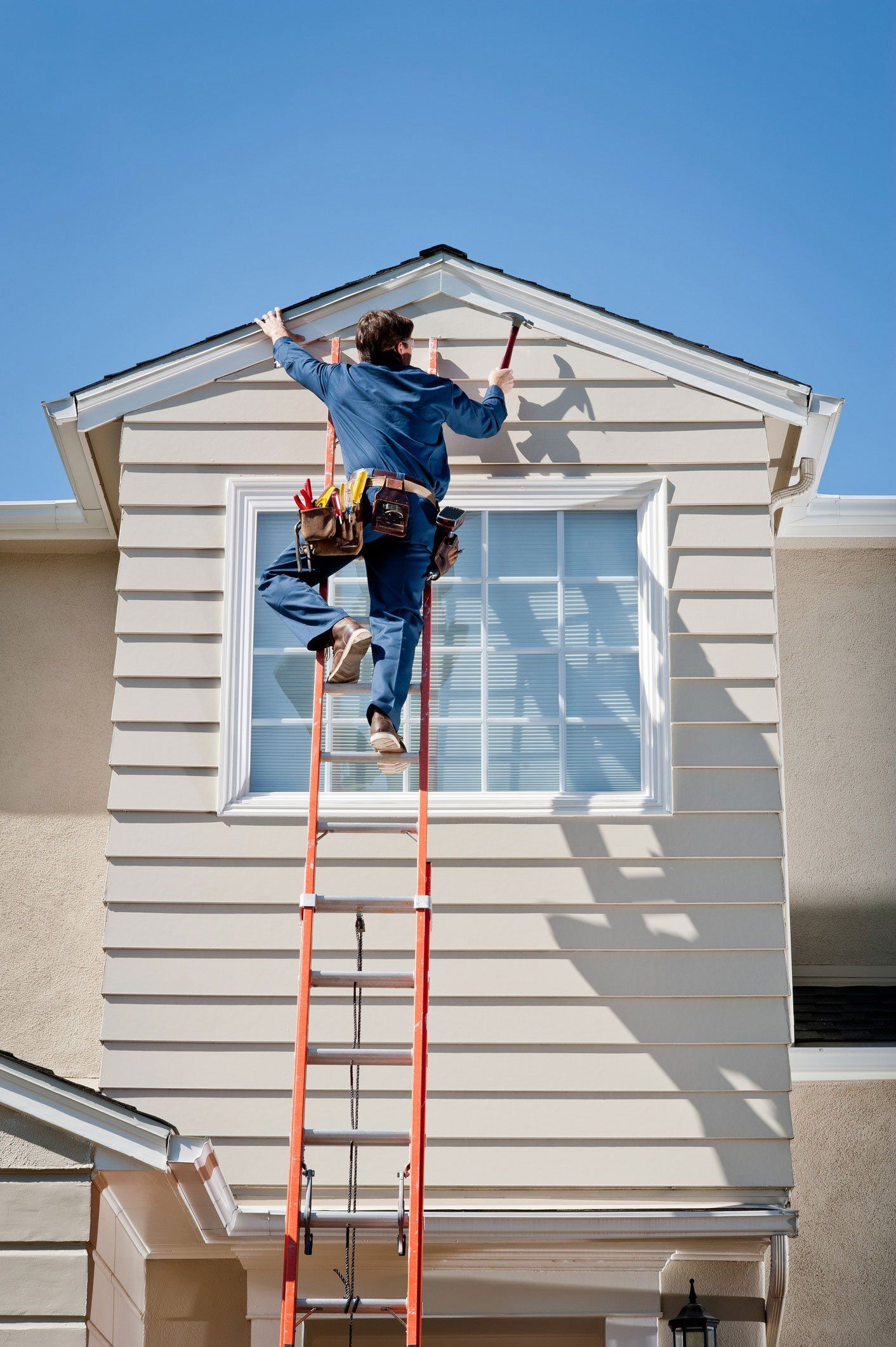 Roofer In Uniform Hammering – Spokane, WA – Galloway Property Maintenance