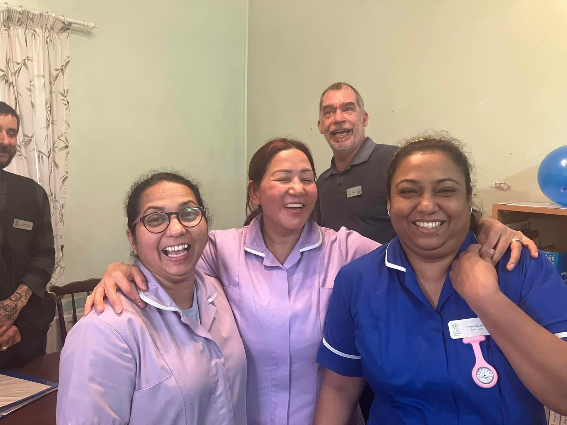 A group of people are posing for a picture in a room.