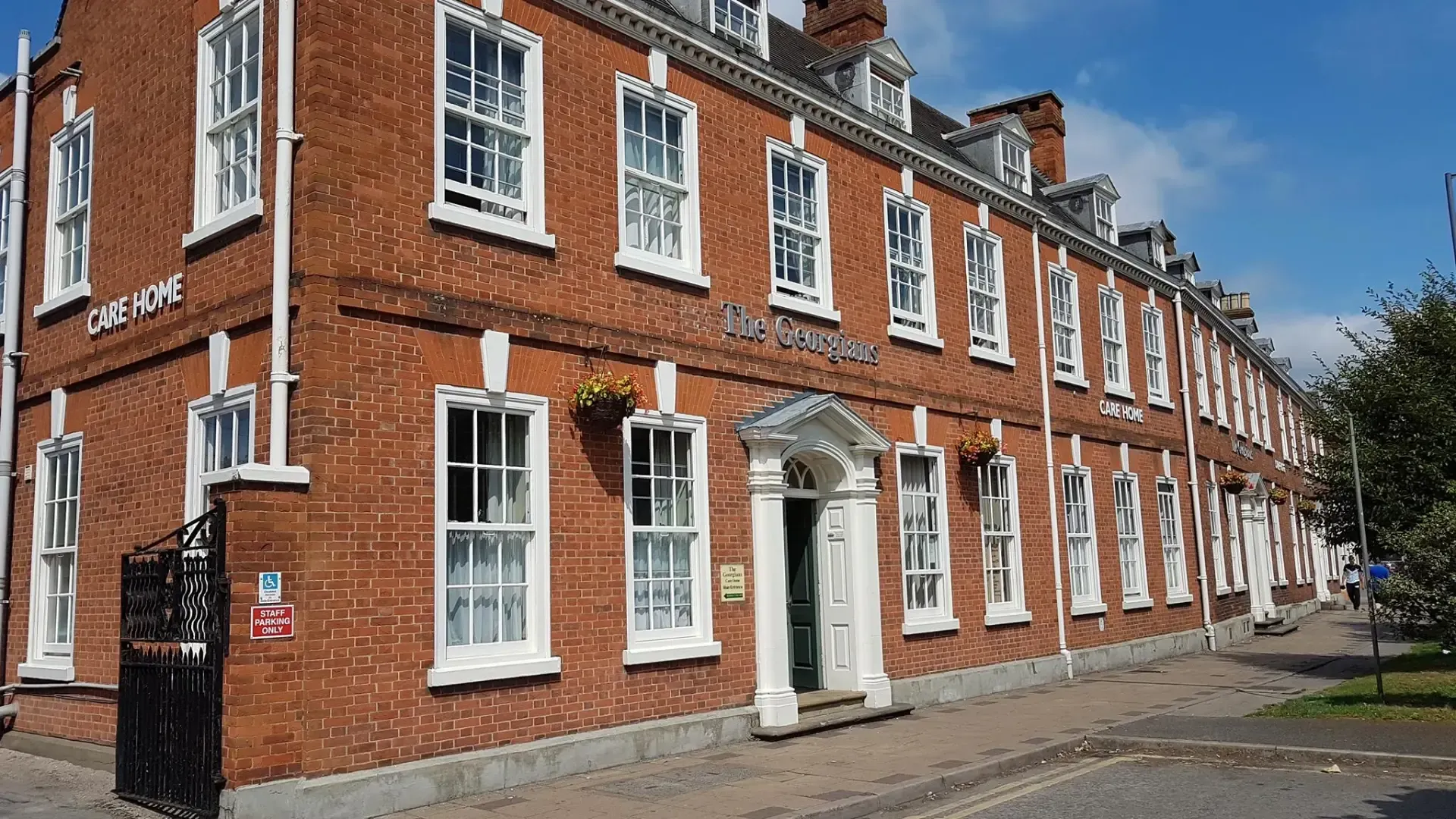 A large brick building with a lot of windows and a sign that says cheshire