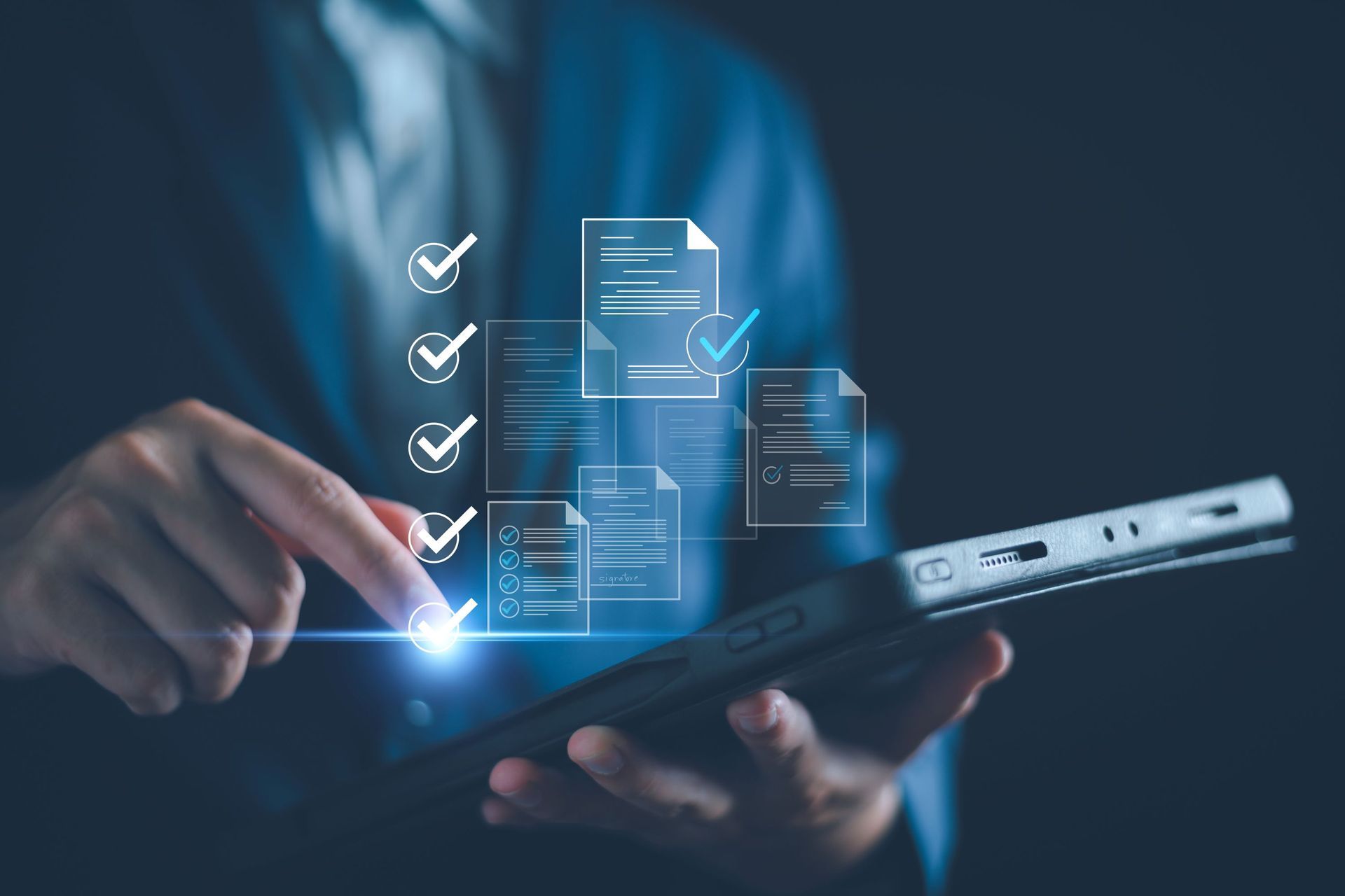 Person holding tablet with digital documents and checklist, blue tones.
