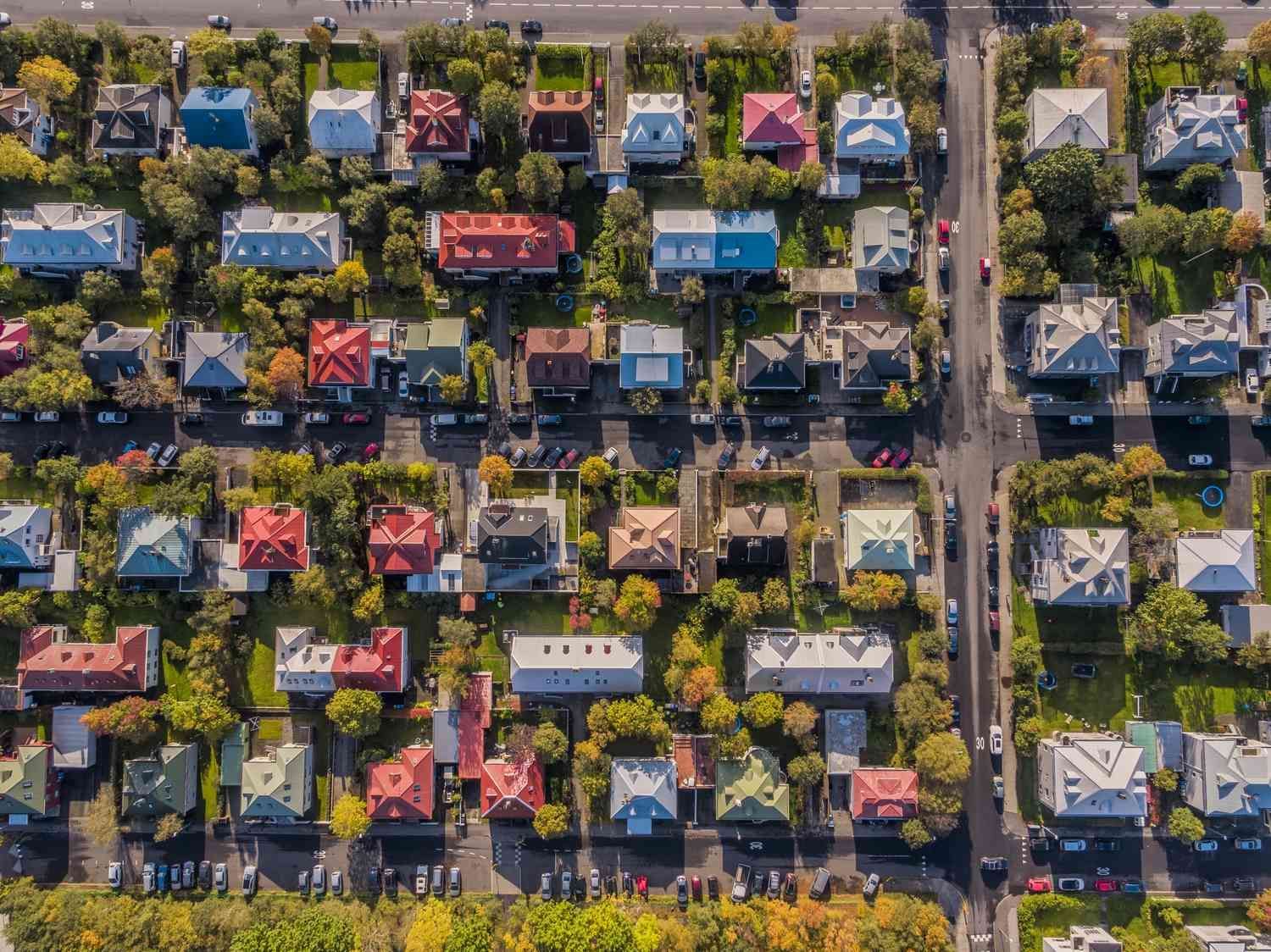 An aerial view of a neighborhood with roads and rooftops of houses