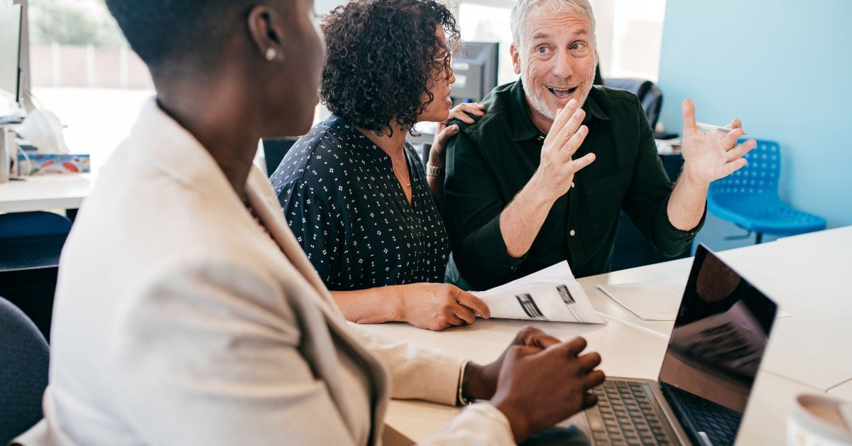 man explaining long term care benefits to other business professionals