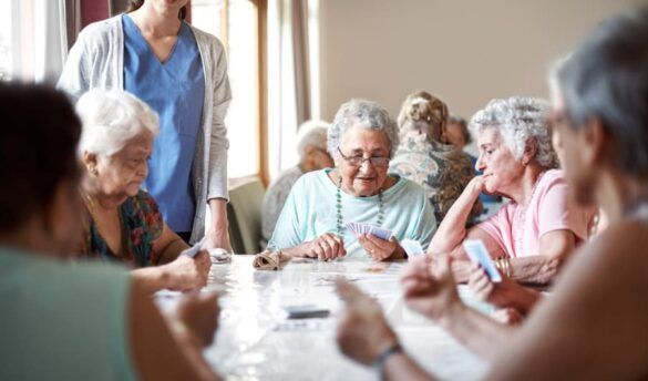 older women playing cards as a senior living community