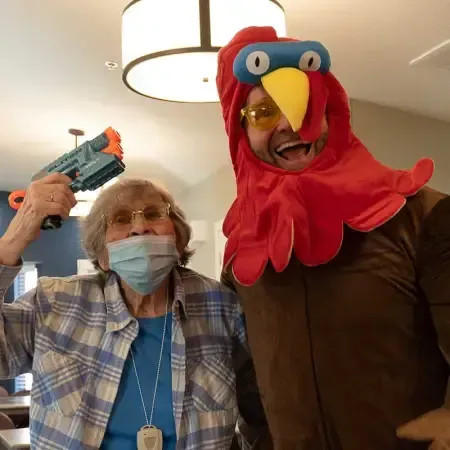 elderly woman with a man dressed as a turkey