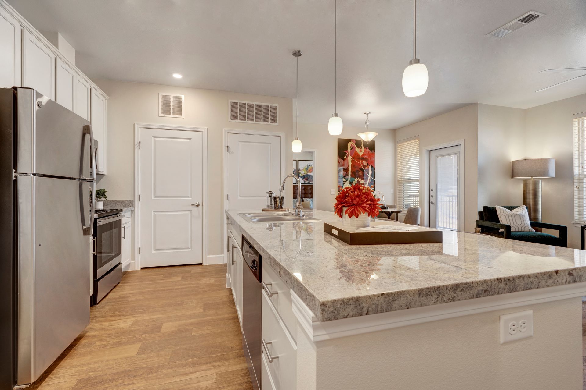 A kitchen with granite counter tops and stainless steel appliances.