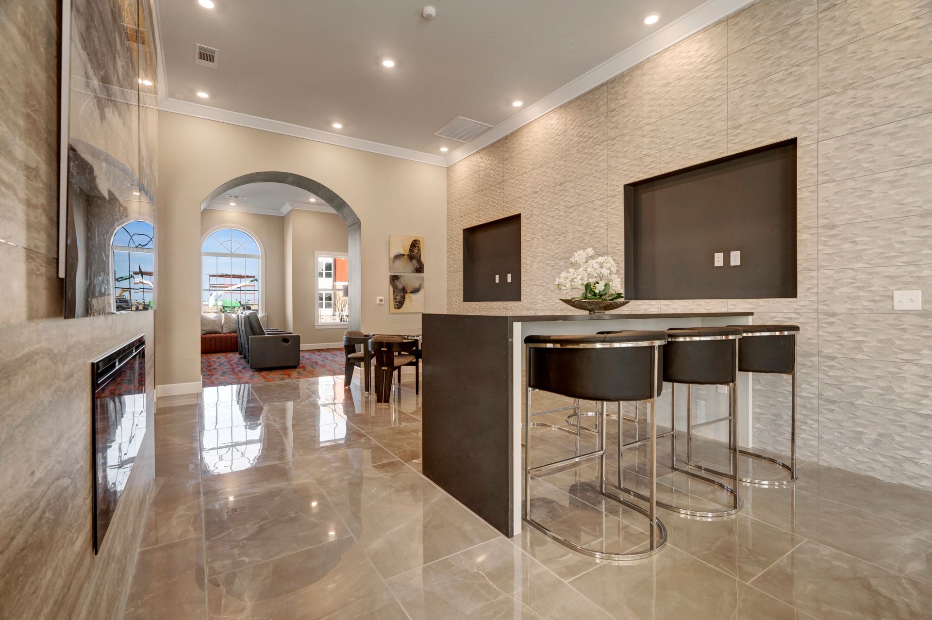 A living room with a table and chairs and a fireplace.