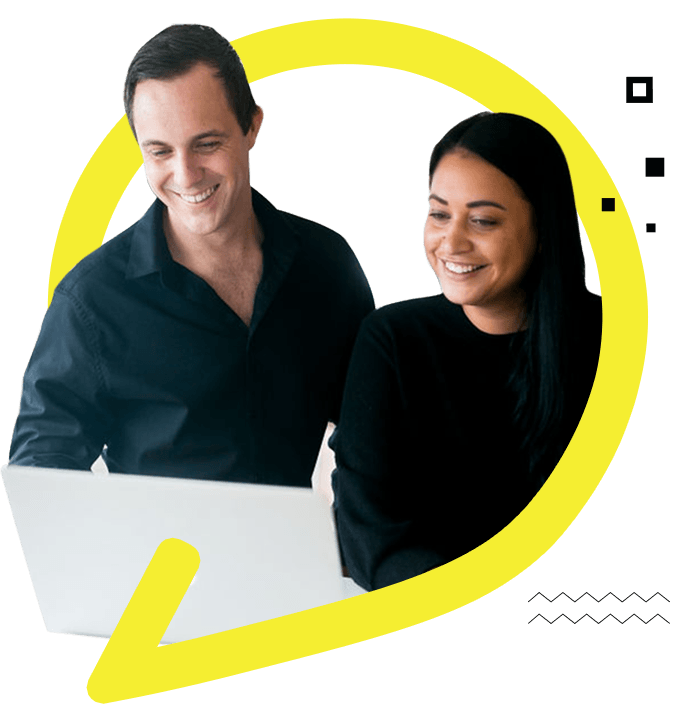 A man And A Woman Smiling While Looking At A Laptop- Apex Ad Agency Team Collaborates With Joy And Enthusiasm