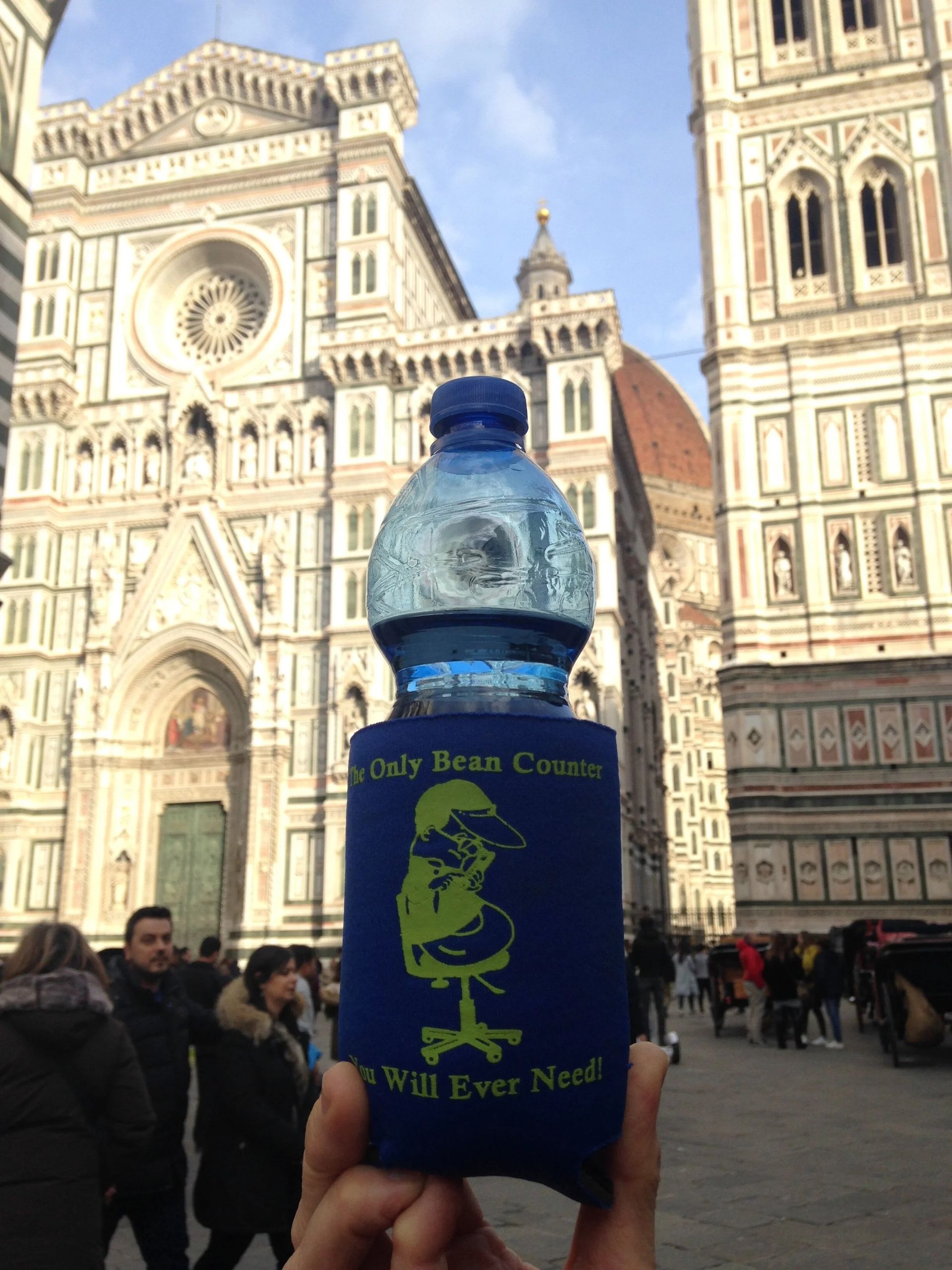 Water bottle in blue koozie in front of Florence Cathedral.