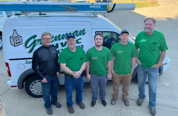 A group of men standing in front of a greenman van