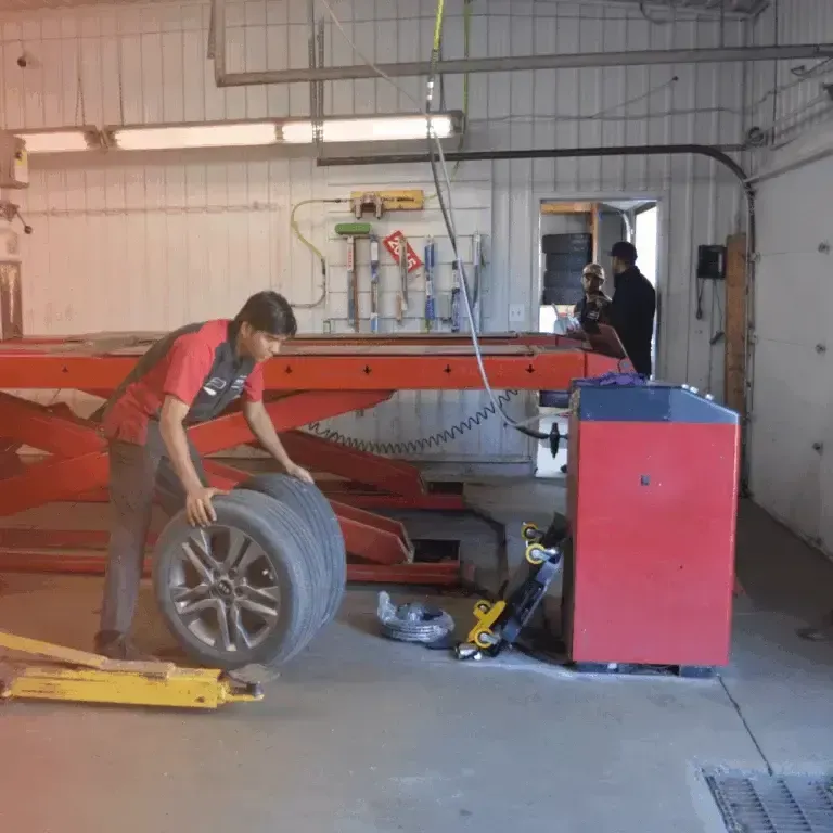 Technician Handling Tire Service In Auto Repair Shop | Dial A Tire Automotive Service Center