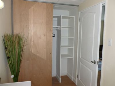 A closet with shelves and a sliding door