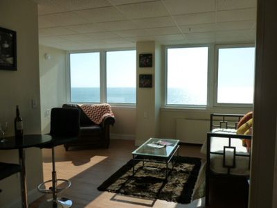 A living room with a view of the ocean
